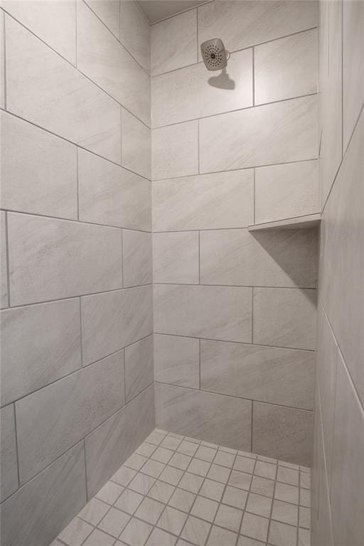 bathroom with a tile shower