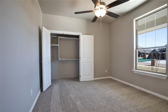 unfurnished bedroom with carpet flooring, a closet, and ceiling fan