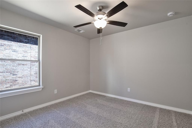 carpeted spare room with ceiling fan