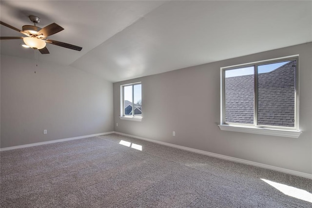 empty room with ceiling fan, carpet floors, and lofted ceiling