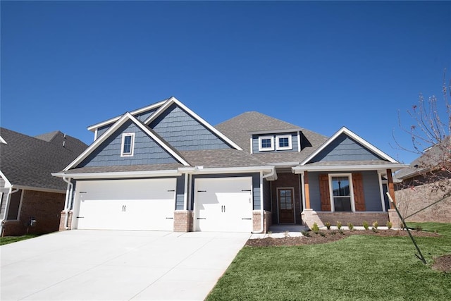 craftsman-style house with a garage and a front lawn