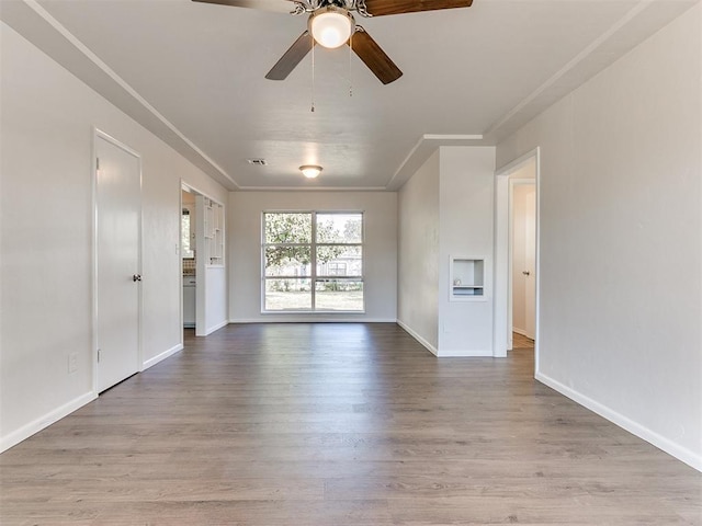 unfurnished living room with ceiling fan, light hardwood / wood-style floors, and crown molding