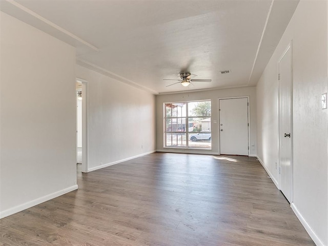 empty room featuring ceiling fan and hardwood / wood-style flooring