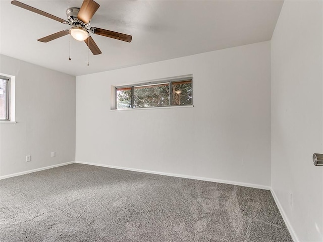 carpeted empty room featuring ceiling fan