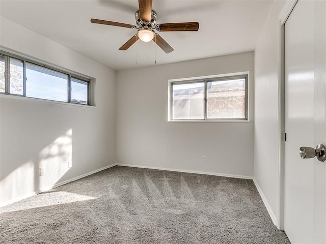 carpeted empty room featuring ceiling fan