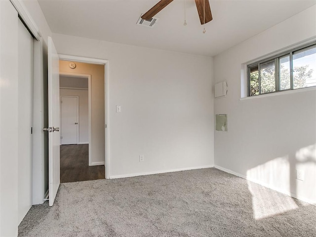 spare room with carpet and ceiling fan