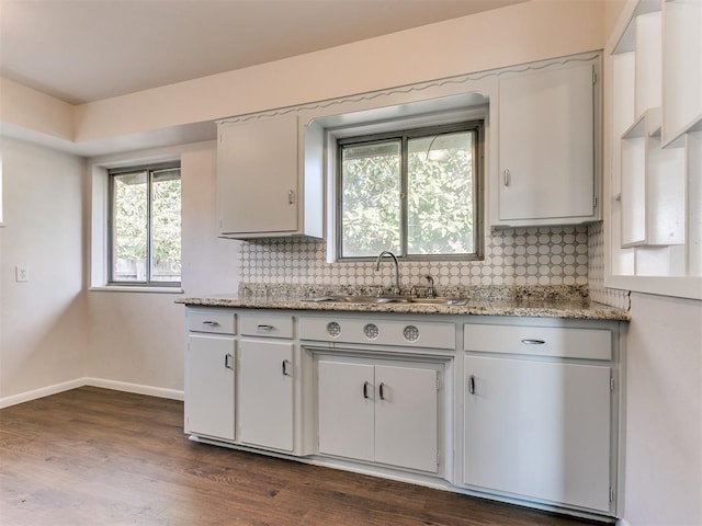 kitchen with tasteful backsplash, a wealth of natural light, and white cabinetry