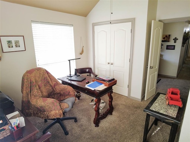 carpeted office space with vaulted ceiling