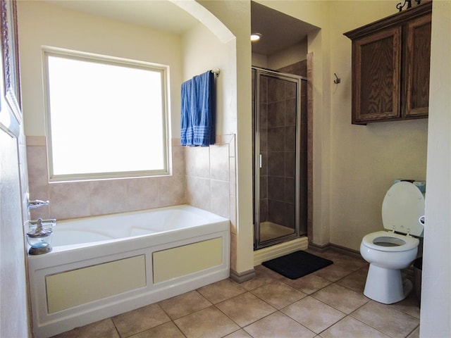 bathroom featuring tile patterned floors, toilet, and plus walk in shower