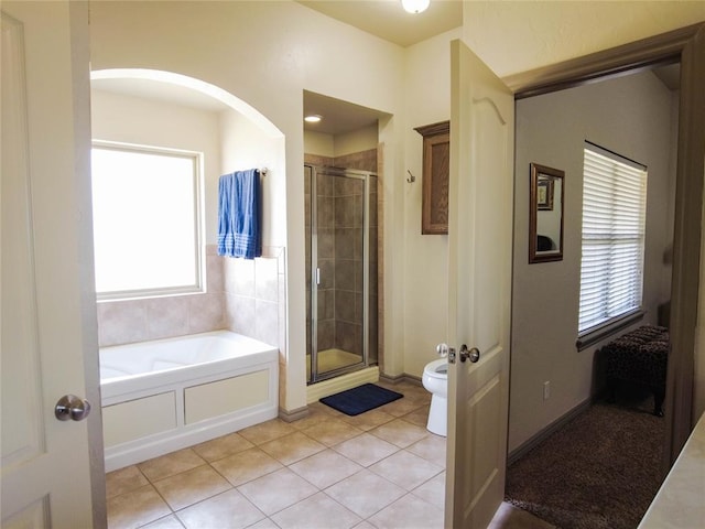 bathroom featuring tile patterned flooring, separate shower and tub, and toilet