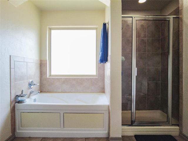 bathroom featuring independent shower and bath