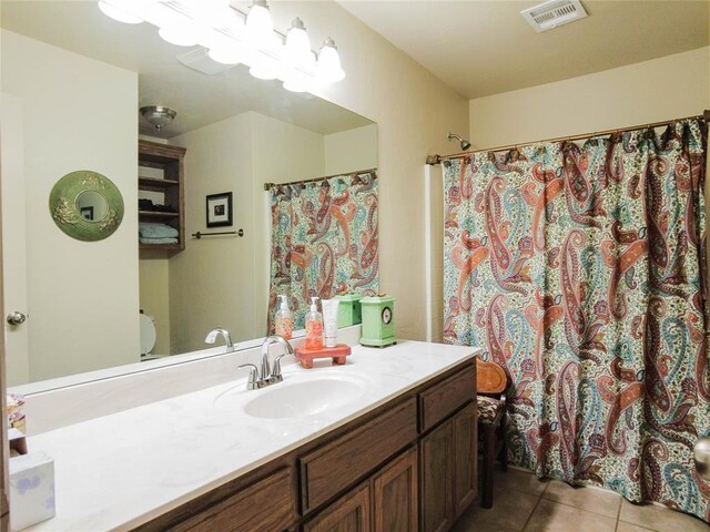 bathroom with toilet, tile patterned flooring, vanity, and a shower with shower curtain