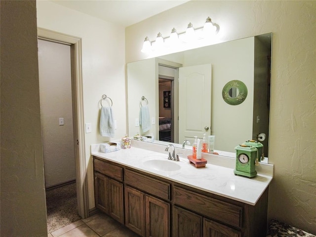 bathroom with tile patterned floors and vanity