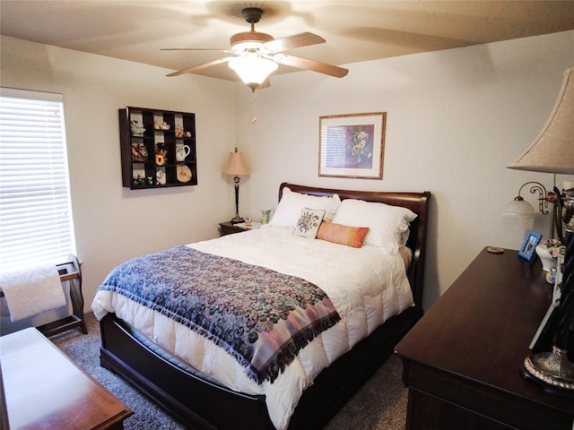 bedroom featuring dark colored carpet and ceiling fan