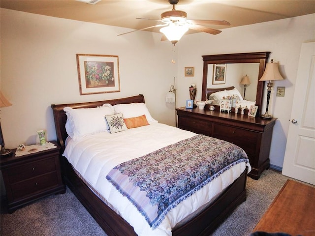 bedroom with ceiling fan and dark carpet