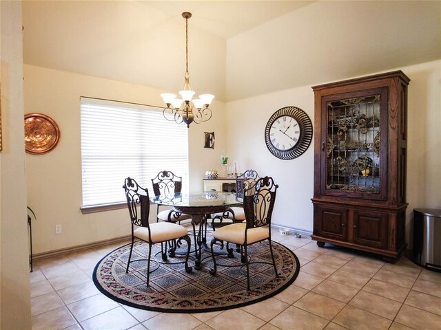 dining area with light tile patterned flooring and an inviting chandelier