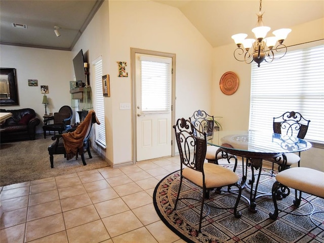 dining area with light tile patterned floors, vaulted ceiling, and a notable chandelier