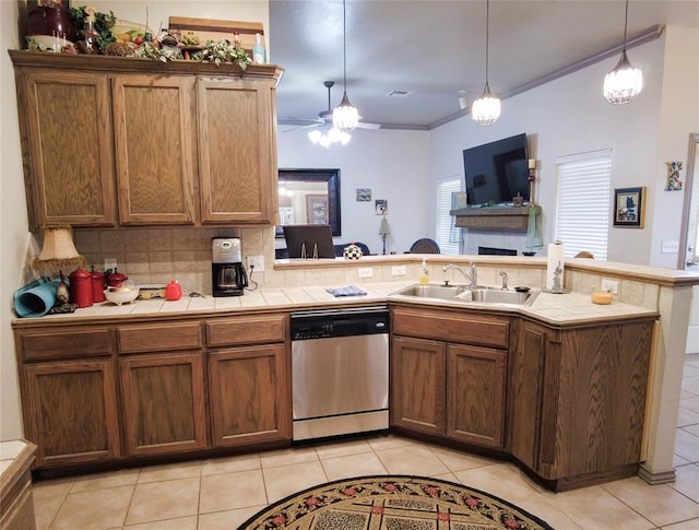 kitchen with stainless steel dishwasher, crown molding, light tile patterned floors, and sink