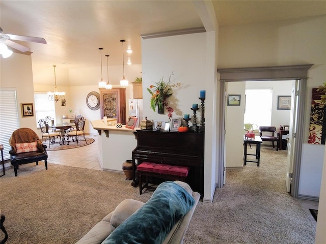 carpeted living room featuring ceiling fan with notable chandelier