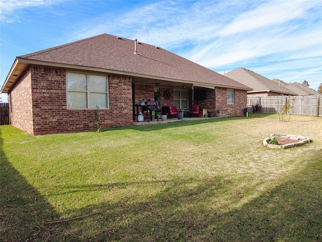 rear view of house with a patio area and a yard