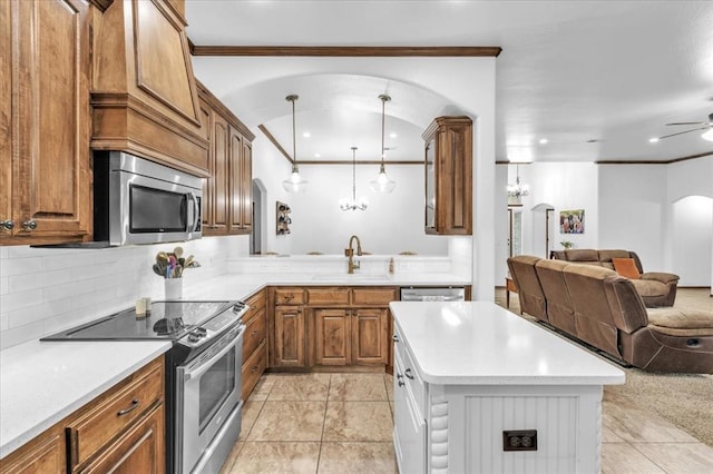 kitchen with pendant lighting, sink, ceiling fan, light tile patterned floors, and appliances with stainless steel finishes