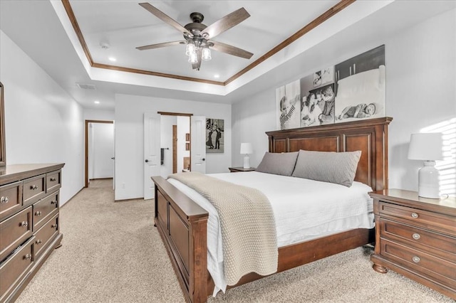 carpeted bedroom with a raised ceiling, ceiling fan, and ornamental molding