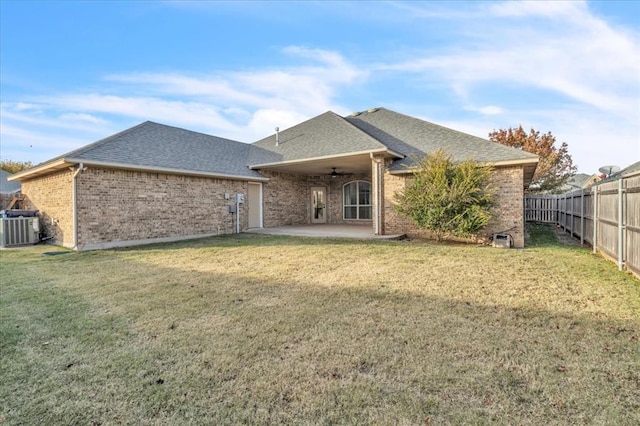 back of property featuring a lawn, a patio area, ceiling fan, and central AC unit