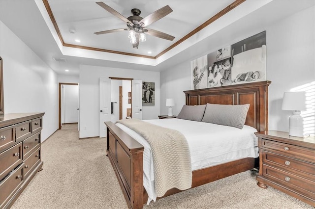 bedroom featuring light carpet, visible vents, ornamental molding, a tray ceiling, and recessed lighting