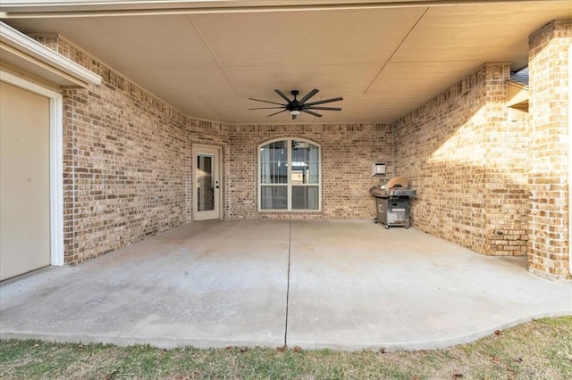 view of patio featuring a ceiling fan, a grill, and a carport