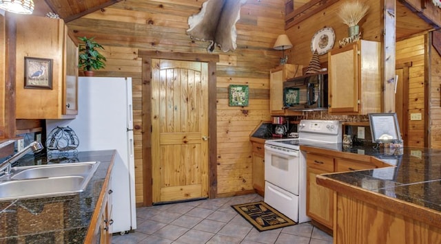 kitchen featuring electric range, sink, vaulted ceiling, wooden walls, and light tile patterned floors