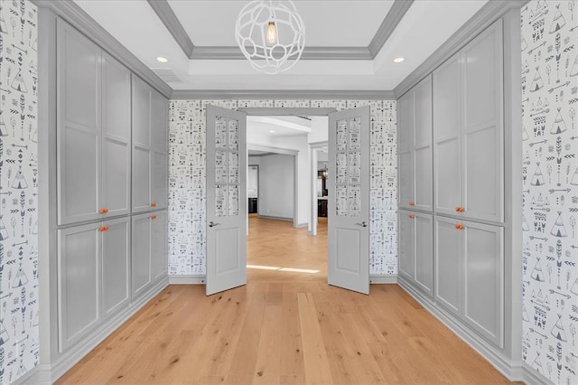 hallway featuring light wood-type flooring and crown molding