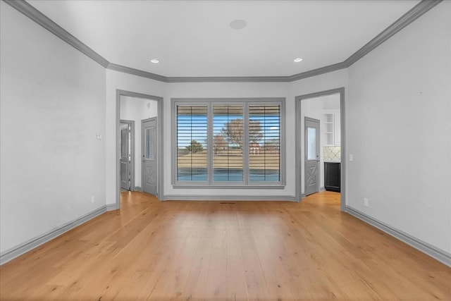 empty room featuring light hardwood / wood-style floors and ornamental molding