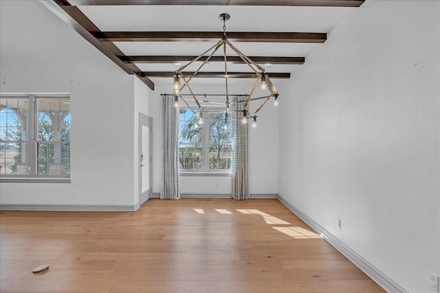 unfurnished dining area with beamed ceiling, light wood-type flooring, and a notable chandelier