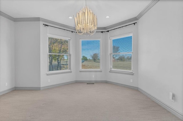 carpeted spare room with crown molding and a chandelier