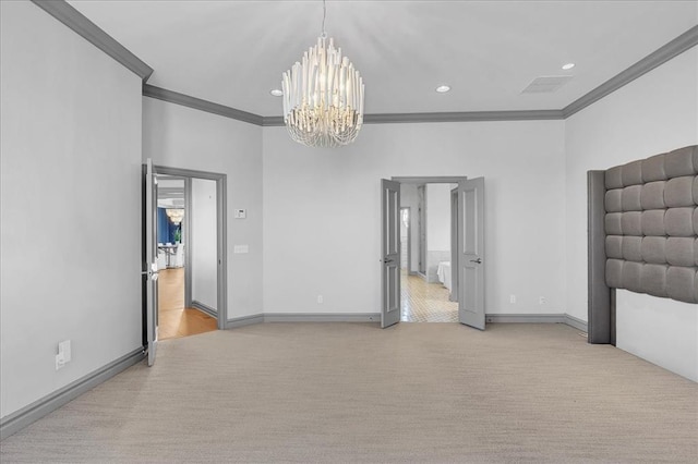 carpeted empty room with a chandelier and crown molding