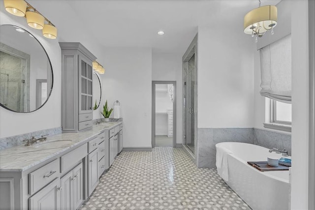 bathroom featuring plus walk in shower, vanity, and tile patterned floors