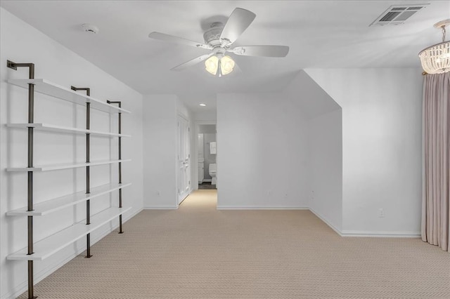 bonus room featuring ceiling fan with notable chandelier and light colored carpet