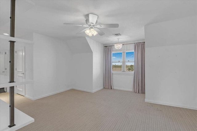 additional living space featuring ceiling fan with notable chandelier, light colored carpet, and vaulted ceiling