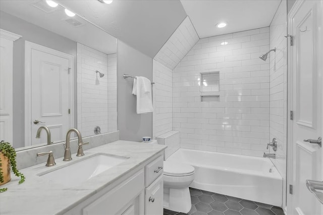 full bathroom with tile patterned floors, vanity, toilet, and tiled shower / bath combo