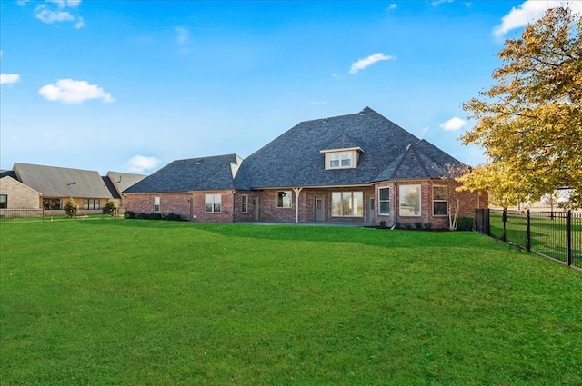 rear view of house with a lawn