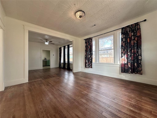 unfurnished living room featuring dark hardwood / wood-style floors and ceiling fan