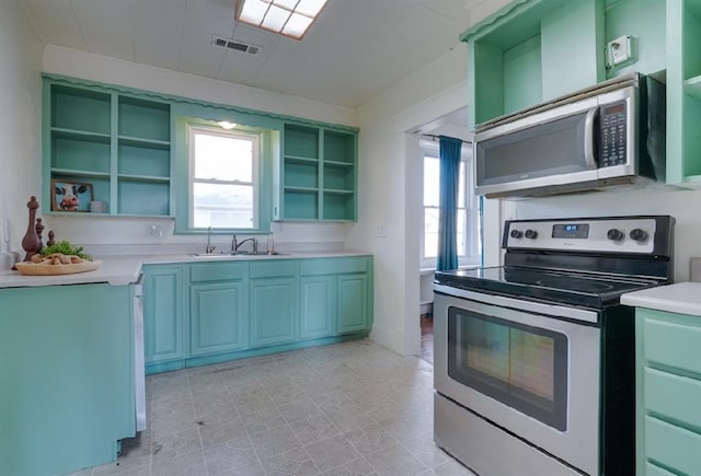 kitchen featuring sink, light tile patterned floors, and appliances with stainless steel finishes