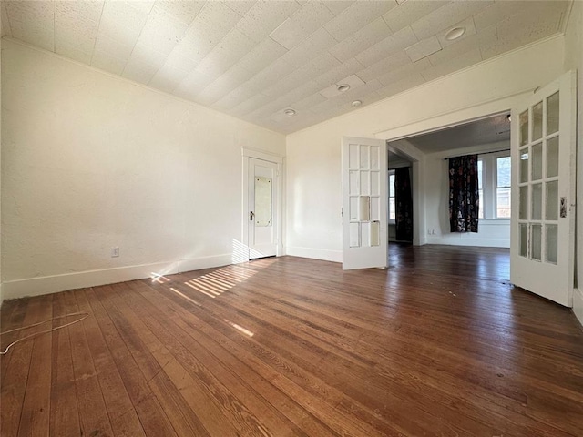 unfurnished room with dark hardwood / wood-style floors and french doors