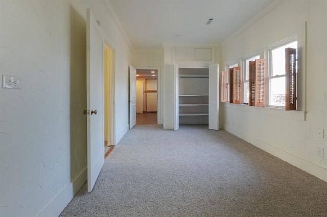 unfurnished bedroom featuring light colored carpet and crown molding