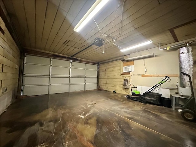 garage with a garage door opener and a wall unit AC