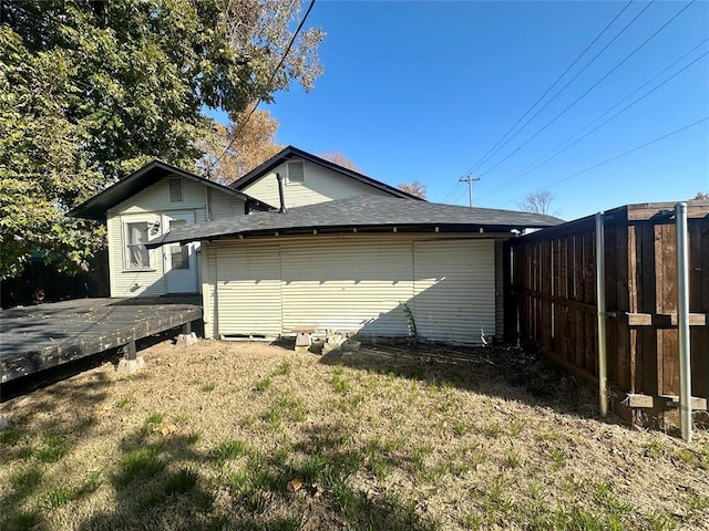 view of property exterior featuring a deck and a yard