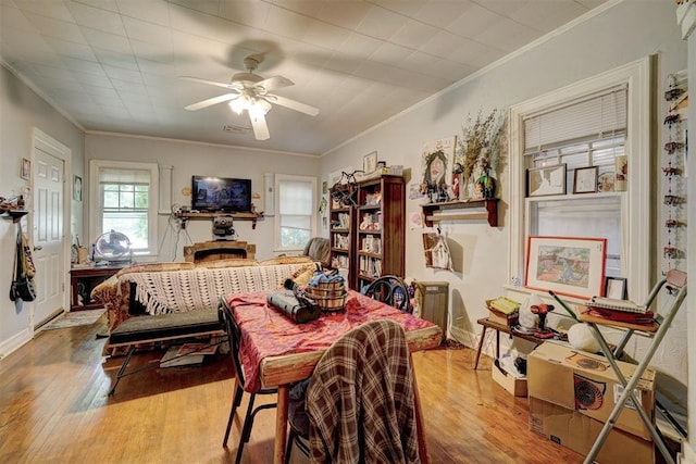 dining room featuring ceiling fan, light hardwood / wood-style floors, and crown molding