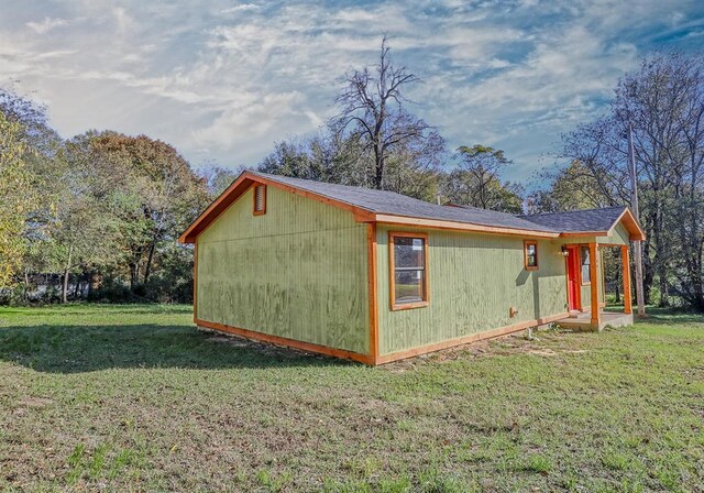 view of side of home featuring a yard