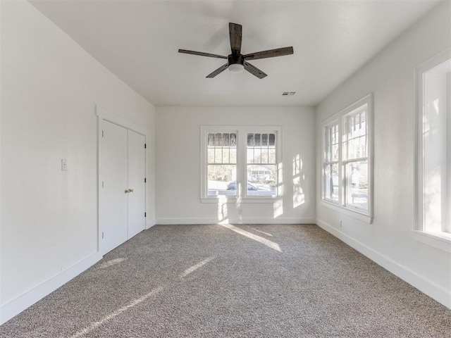 carpeted empty room with ceiling fan