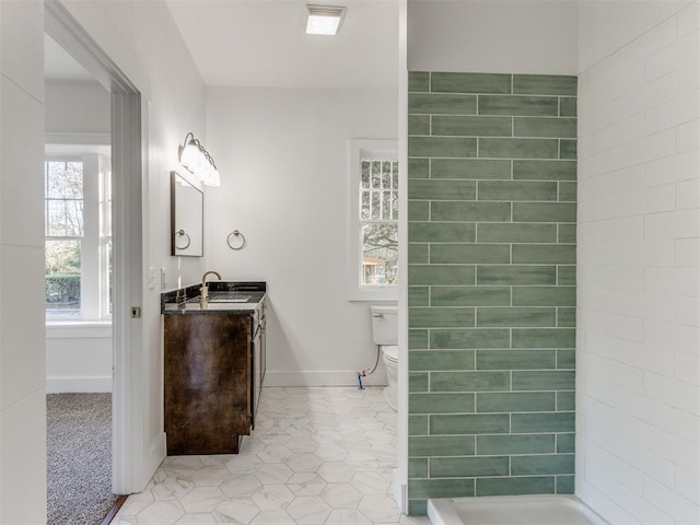 bathroom featuring tile patterned floors, vanity, and toilet